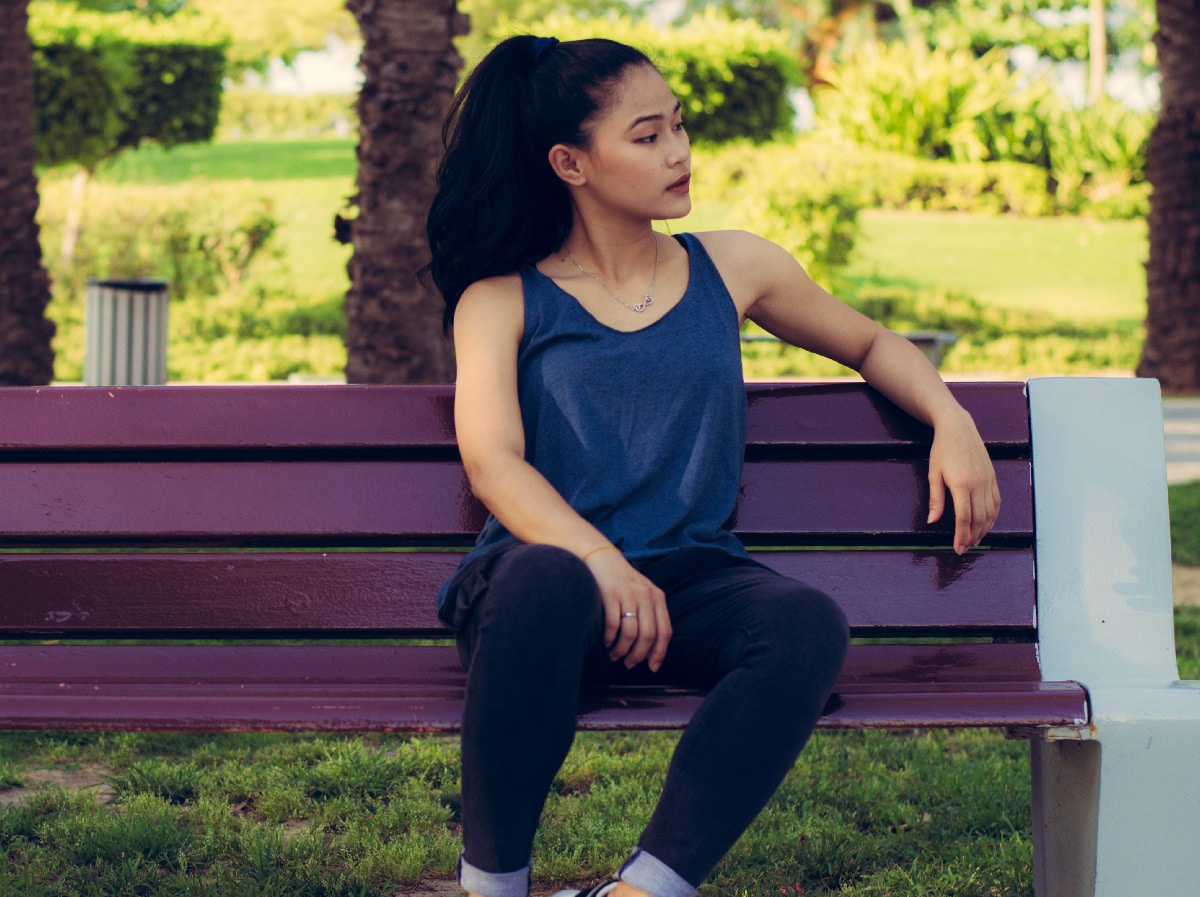 woman resting on a park bench