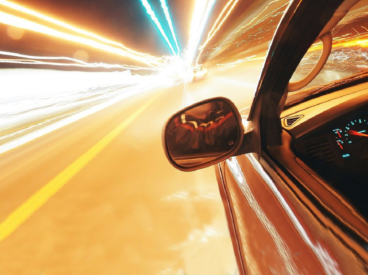 car driving fast late at night