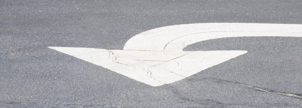 white arrow painted on road