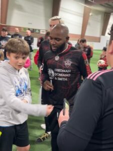 signing autographs after soccer game