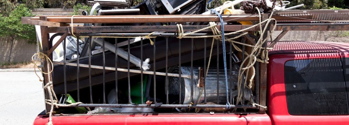 red pickup truck overloaded