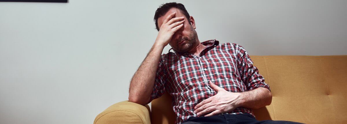 man with abdominal pain and a headache