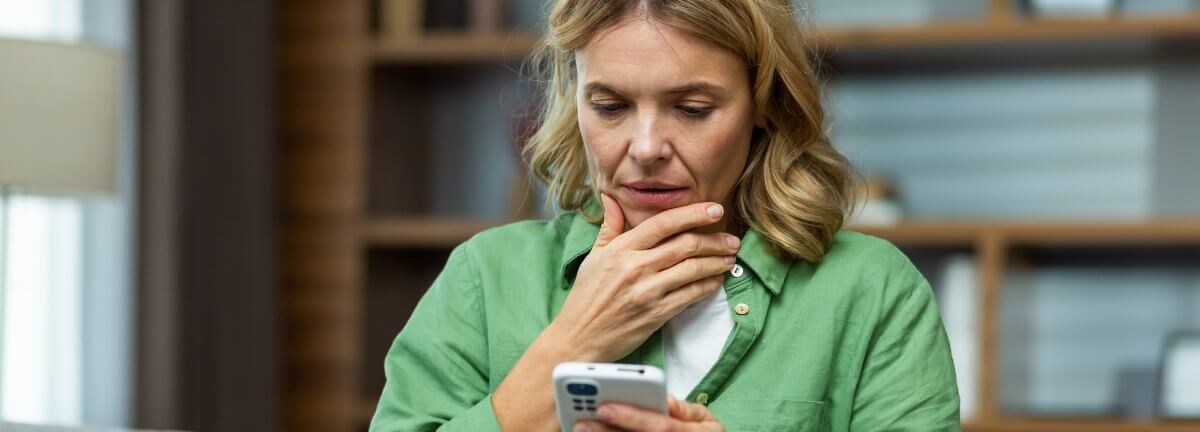 woman concerned looking at phone