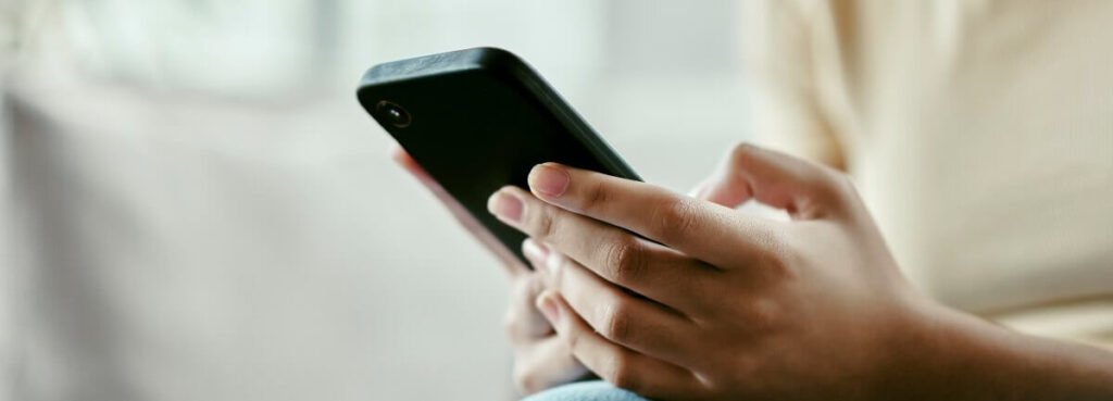 holding smartphone while sitting down