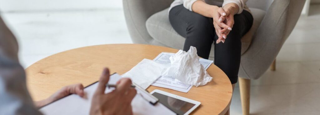 woman meeting with therapist in office