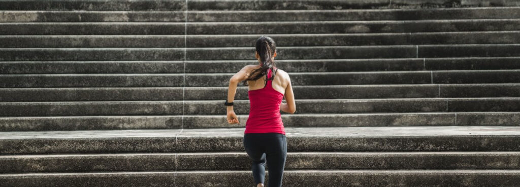 woman running up concrete stairs