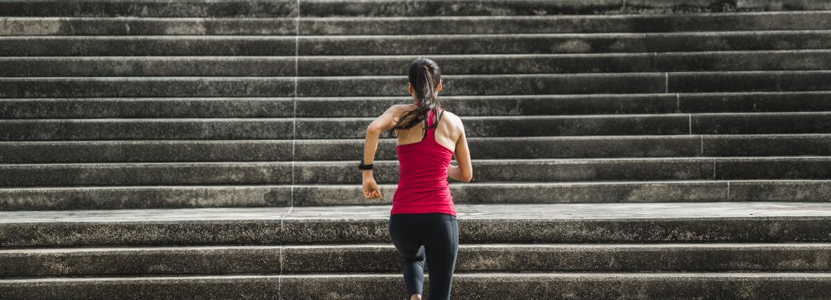 woman running up concrete stairs