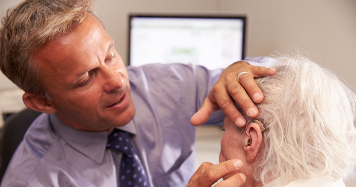 A man examining a woman's hear